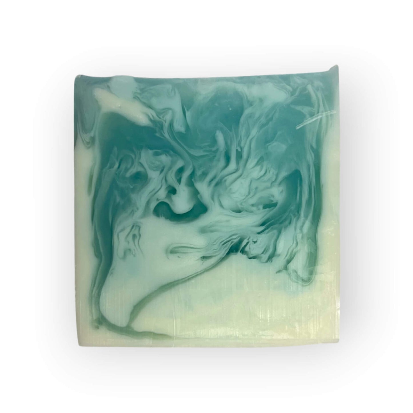 Handcrafted Ocean Breeze Goat Milk soap bar with notes of fresh sea salt, and sandalwood, with soothing blue hues without a label.